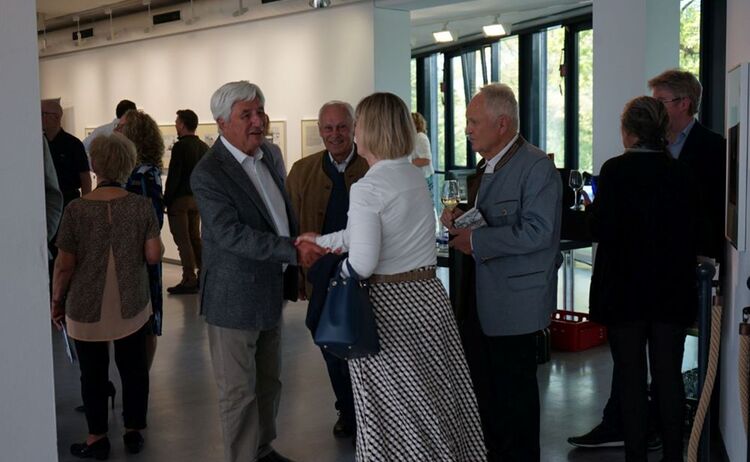 Ausstellungsbesucherinnen und Besucher im Gespräch: Zum Vergrößern auf Bild klicken